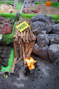 Pedazos de madera del ocote con cartulina y la palabra ocote encima y carb&oacute;n vegetal