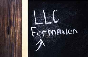 Fototapeta premium LLC FORMATION Limited liability company- concept text on chalk board.