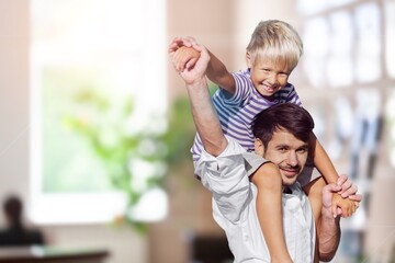 Happy father with child playing at home living room.