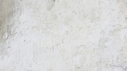 White gray old wall with shabby damaged plaster. Vintage dirty cement plastered wall background. White space for text.