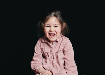 pretty girl making expressive faces in the studio against a black background