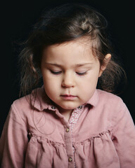 pretty girl making expressive faces in the studio against a black background