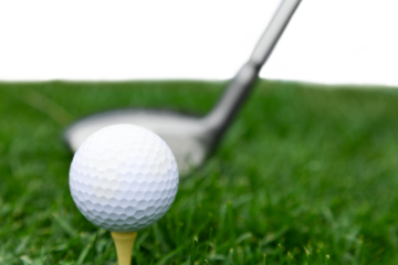 Golf Ball on Tee and Club on Golf Course