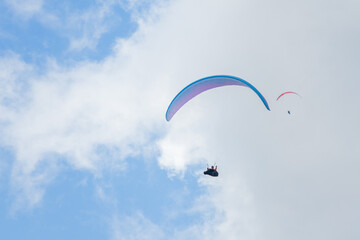 A paraglider flight in a blue sky with clouds.
Paragliding, paraglider, paraglider pilot, flying, fly