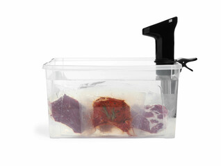 Thermal immersion circulator and meat in box on white background. Vacuum packing for sous vide...