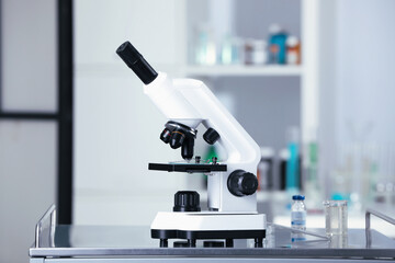 Modern medical microscope on gray table in laboratory