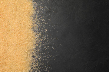 Brown sugar on black table, top view. Space for text