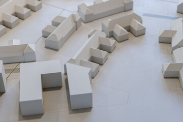 Top view of white architectural models. Architect's design thinking process. Urban planning model. Architecture studio working area on table.