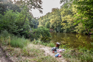 Panorama of a natural environment of forest and woods polluted with littering of plastic and...