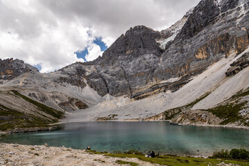 Five color sea, a hidden glacier pool in the mountains in Yading, Sichuan, China. Copy space for text, sky with clouds
