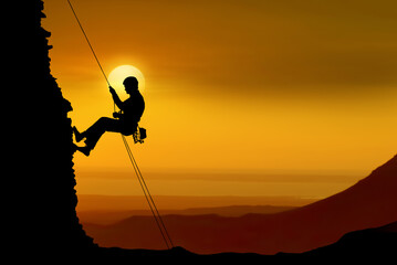 Silhouette of a rock climber over beautiful sunset - 543332980