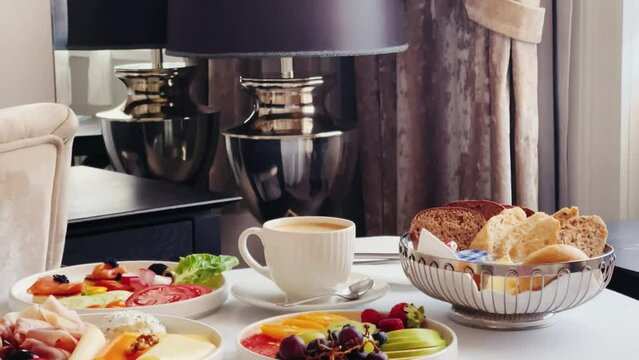 Luxury hotel and five star room service, various food platters, bread and coffee as in-room breakfast for travel and hospitality. High quality 4k footage