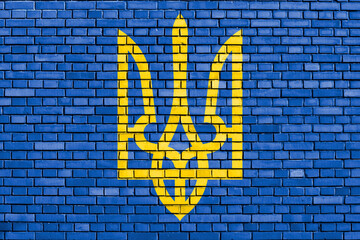 Coat of Arms of Ukraine painted on brick wall
