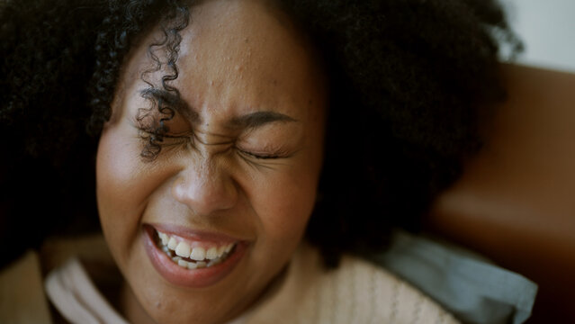 Black Woman Laughing At A Joke On Mobile Phone