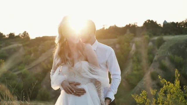 cheerful couple in love, bride and groom cheerfully and laughing posing at sunset