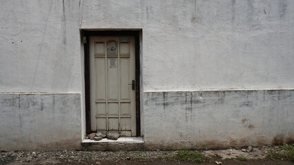 broken white old wooden door and wall with copy space.