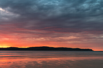 Colourful cloud filled sunrise at the seaside