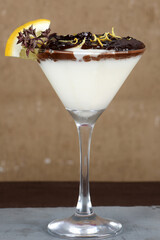 white sweet strawberry ganache dessert with chocolate and lemon zest served in a glass bowl.