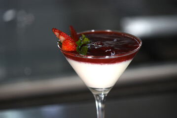 white sweet strawberry ganache dessert with chocolate and lemon zest served in a glass bowl.
