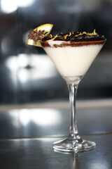 white sweet strawberry ganache dessert with chocolate and lemon zest served in a glass bowl.