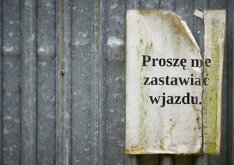 Sign with the inscription proszę nie zastawiać wjazdu on the door of a construction container in Poland white copy space on left side. Translation: please do not block the entrance