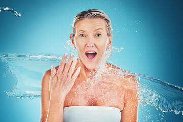 Beauty splash, senior woman and wow face in studio for cleaning, fresh and grooming on blue...