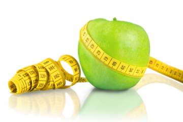 Green apple with measuring tape isolated on white