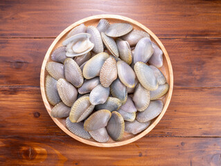 Striped Clam or Clam bivalve molluscs  on wooden background for seafood dish. © KT Studio