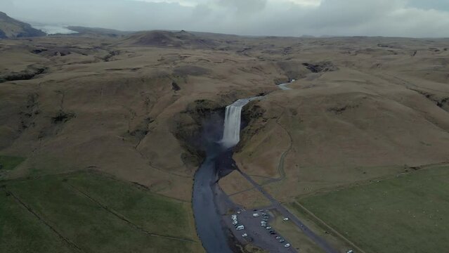 Skógafoss waterfall and surrounding rural landscape, Iceland. Aerial orbiting