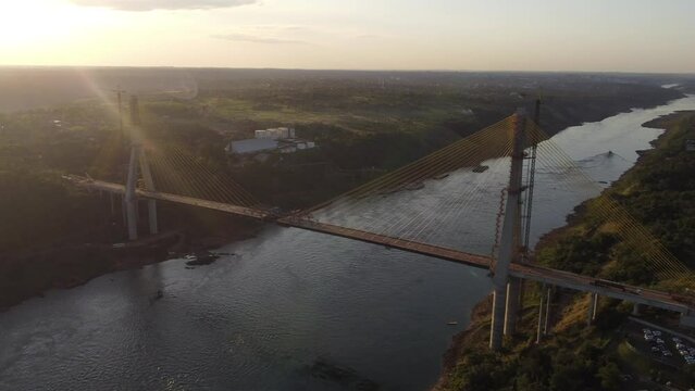 International Bridge of Integration over Uruguay River connecting Sao Borja in Brazil and Santo Tom&eacute; in Argentina. Aerial drone at sunset with sunflare