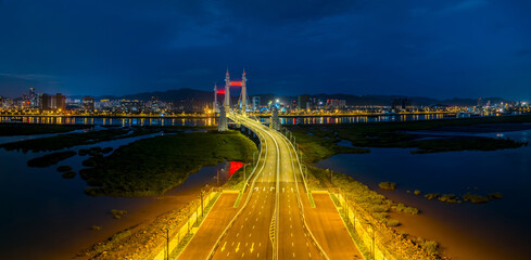 Fototapeta premium Urban road and bridge with skyline in Zhoushan at night, Zhejiang, China.