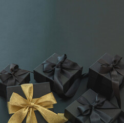 Black Friday Sale and Christmas. Gift boxes one with gold ribbon, overhead