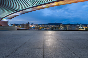 Empty square floor and urban skyline with building scenery at night