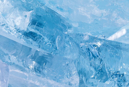 Abstract blurred winter background with a chipped large blue ice floe on Baikal Lake on a sunny frosty day. Natural cold backdrop with empty space for text, mockup, blank