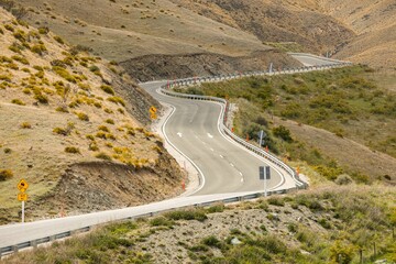 Scenic view of a twisty road in mountains leading to Queenstown, New Zealand