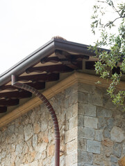 detail of a roof with rain gutter and downspout - 543359973