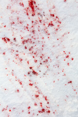 Drops of blood on white snow