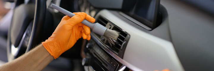 Brush cleaning of dust from car interior parts