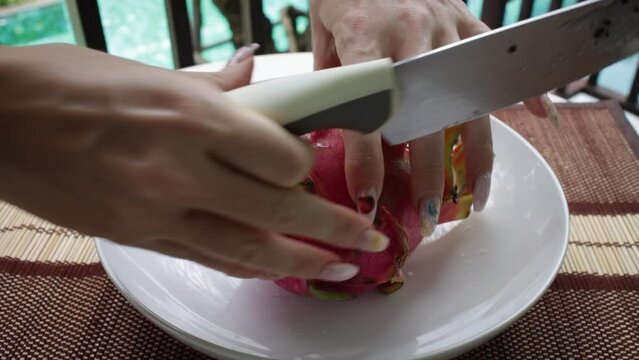 Female hands holding fresh ripe organic dragon fruit or pitaya, pitahaya. Exotic fruits, healthy eating concept