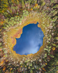 The picture presents lake surrounded by trees in autumn colours. This lake is located in Kashubian Landscape Park, Nature Reserve "Żurawie Chrusty", Poland. © Piotr