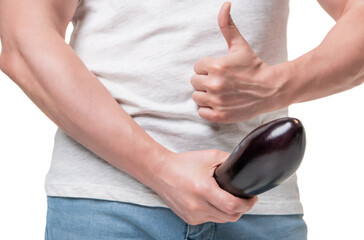 Guy crop view giving thumb holding eggplant at crotch level imitating large penis isolated on white - obrazy, fototapety, plakaty