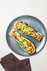 Zucchini stuffed with mushrooms, tomatoes and cheese. Healthy eating. Vegetarian food. Diet.