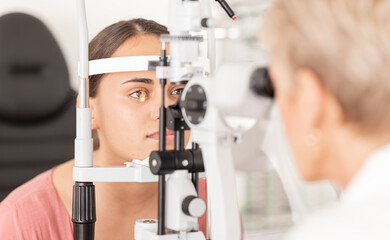 Woman at eye lens test, healthcare for vision by optician for contact lens and focus with laser...