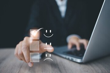 Customer service and Satisfaction concept, Business people touching the virtual screen on the happy Smile face icon to give satisfaction in service.