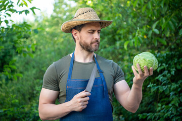 man greengrocer in straw hat cut cabbage with knife