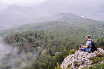 Fototapeta premium Hiker admiring the landscape on top of the mountain.