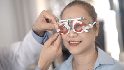 Asian elderly woman measuring her eyesight