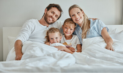 Family, children and bed with a girl, sister and parents in the bedroom of a home to relax together...