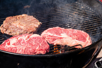 Beef rib eye steaks and outdoor barbecue are grilled. Cooking steaks on the grill.