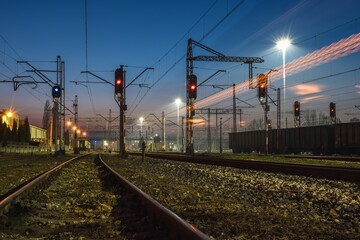 Railway station in the evening scenery. Railroad tracks at Kielce Herby station, Poland.